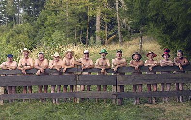 Naked gardeners behind a fence.,